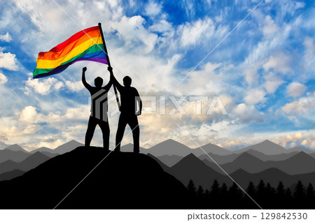 Silhouette of a gay couple with rainbow flag at the top 129842530