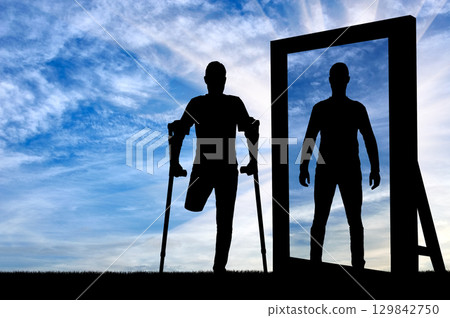 Silhouette of a man with an amputated leg with crutches 129842750