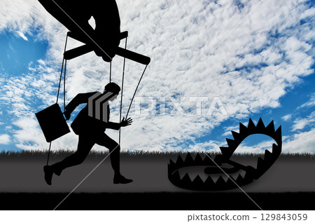 Man marionette running into a trap 129843059