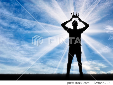 Silhouette of a selfish and narcissistic man reconciling his own crown Silhouette of a selfish and narcissistic man reconciling his own crown 129843208