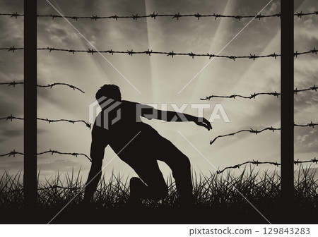 Silhouette of a refugee who illegally cross the border 129843283