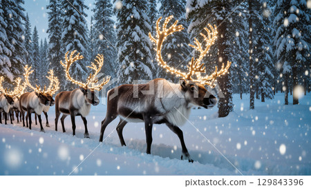 Christmas reindeer walking through snowy forest with glowing lights on antlers in magical winter atmosphere 129843396