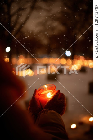A Candlelight Vigil taking place amidst the serene Winter Snow creates a special atmosphere 129843787