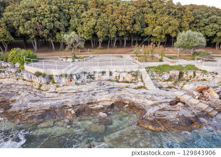 Rocky coastline with clear turquoise water in Istria, Croatia. Rocky coastline with clear turquoise water in Istria, Croatia. 129843906