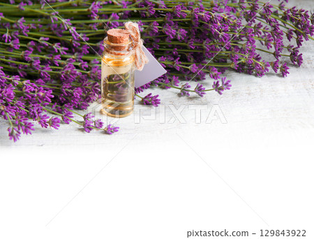 Lavender flowers and oil in the bottle 129843922