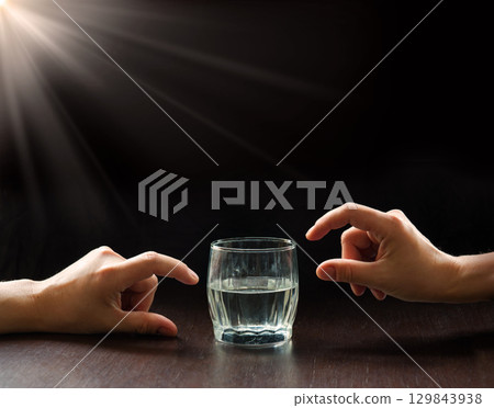An optimist and a pessimist's opinion about a glass of water An optimist and a pessimist's opinion about a glass of water 129843938