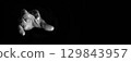 A hand is extended to take 129843957