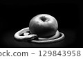 The snake lies near the apple 129843958