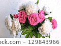 Bouquet of peonies and roses on a table 129843966