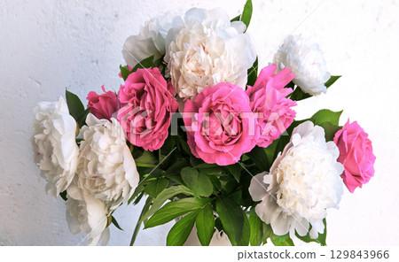 Bouquet of peonies and roses on a table Bouquet of peonies and roses on a table 129843966