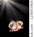 Asking hands on black backdrop 129843969