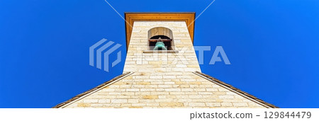 Stone Church Bell Tower Bright Blue Sky Summer Day Architecture old high view wall roof icon holy 129844479