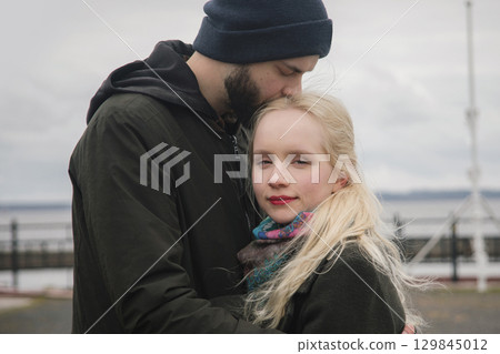 Romantic young woman with blond hair and handsome man outdoors. Happy couple 129845012