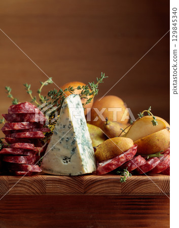 Blue cheese, dry-cured sausages, thyme and pears. 129845340