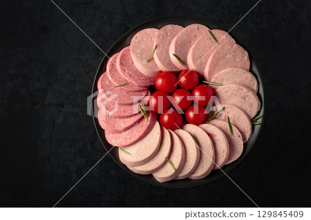 Various boiled sausages with tomatoes and rosemary. Various boiled sausages with tomatoes and rosemary. 129845409