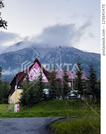 Vysoke Tatry, Slovakia - August 4, 2025: View of the Tatra Mountains and houses from the streets of town. 129845478