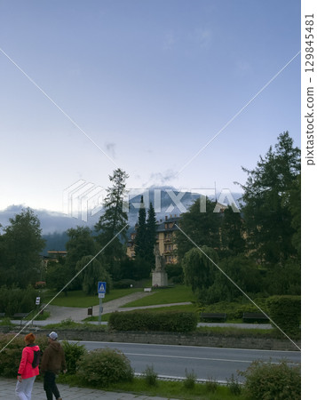 Vysoke Tatry, Slovakia - August 4, 2025: View of the Tatra Mountains and houses from the streets of the town. Vysoke Tatry, Slovakia - August 4, 2025: View of the Tatra Mountains and houses from the streets of the town. 129845481