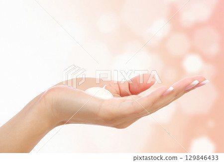Female hand against an abstract background Female hand against an abstract background 129846433