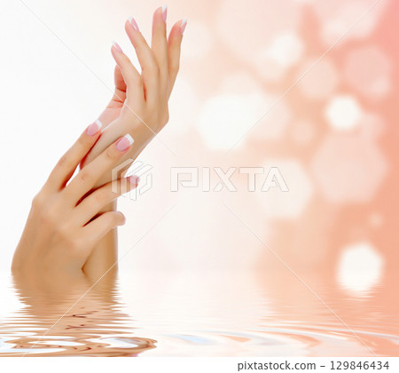 Female hands against an abstract background 129846434