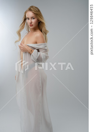Blonde woman poses elegantly in a studio, showcasing beauty and confidence Blonde woman poses elegantly in a studio, showcasing beauty and confidence 129846455