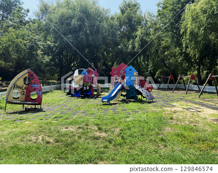 Broken swings on a playground in Bucharest, Romania Broken swings on a playground in Bucharest, Romania 129846574