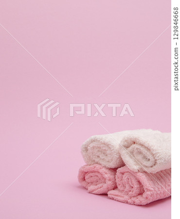 Stack of towels on pink background Stack of towels on pink background 129846668