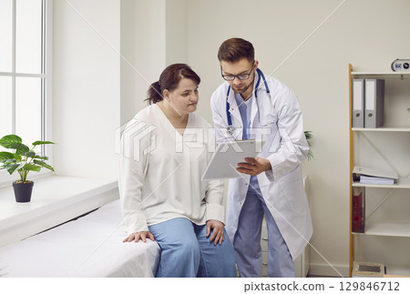Male physician talking to female patient about results of her medical examination Male physician talking to female patient about results of her medical examination 129846712
