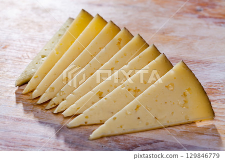 Slices of semi-hard cheese Slices of semi-hard cheese 129846779