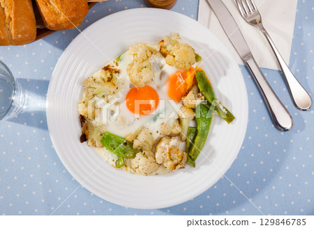 Tasty fried eggs with cauliflower Tasty fried eggs with cauliflower 129846785