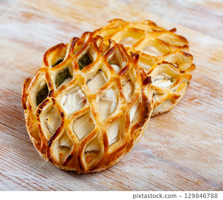 Puffs with goat cheese and spinach on wooden background 129846788