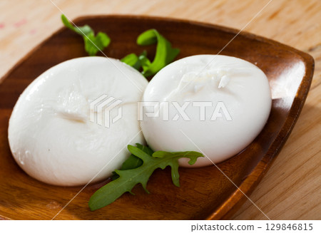 Italian cheese burrata with fresh arugula Italian cheese burrata with fresh arugula 129846815