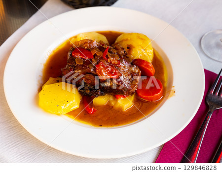 Baked lamb shoulder with vegetables Baked lamb shoulder with vegetables 129846828