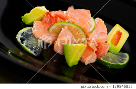 Salmon ceviche with avocado and lime 129846835
