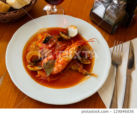Tail of monkfish with shellfish, prawns Tail of monkfish with shellfish, prawns 129846836
