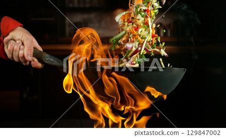 Freeze Motion of Flying Asian Wok Ingredients with Fire Flames Freeze Motion of Flying Asian Wok Ingredients with Fire Flames 129847002