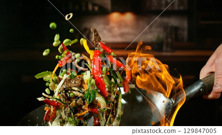 Freeze Motion of Flying Asian Wok Ingredients with Fire Flames 129847005