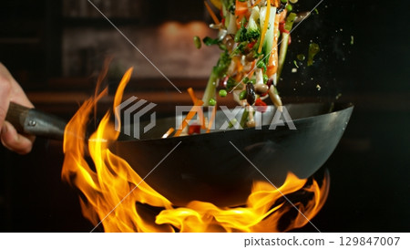 Freeze Motion of Flying Asian Wok Ingredients with Fire Flames 129847007