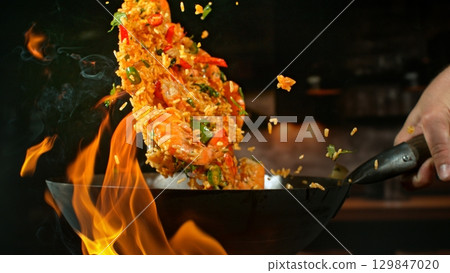 Freeze Motion of Flying Asian Wok Ingredients with Fire Flames 129847020