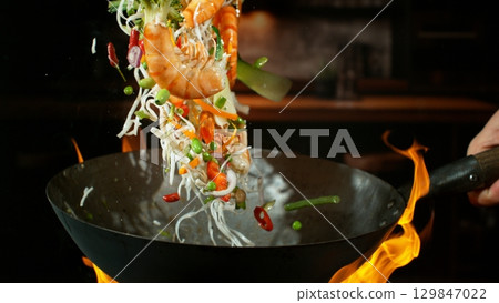 Freeze Motion of Flying Asian Wok Ingredients with Fire Flames 129847022