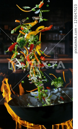 Freeze Motion of Flying Asian Wok Ingredients with Fire Flames 129847023