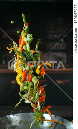 Freeze Motion of Flying Asian Wok Ingredients with Fire Flames 129847025