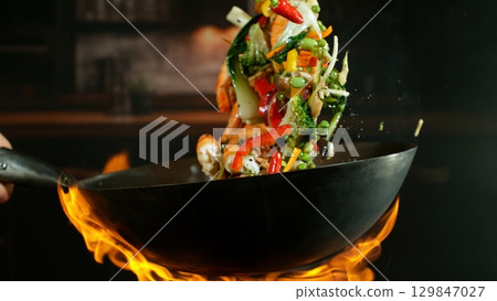 Freeze Motion of Flying Asian Wok Ingredients with Fire Flames 129847027