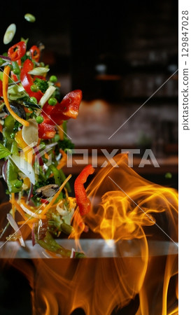 Freeze Motion of Flying Asian Wok Ingredients with Fire Flames 129847028