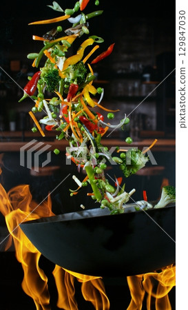 Freeze Motion of Flying Asian Wok Ingredients with Fire Flames 129847030