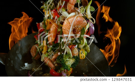 Freeze Motion of Flying Asian Wok Ingredients with Fire Flames 129847031
