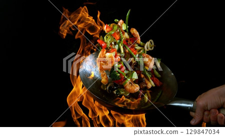 Freeze Motion of Flying Asian Wok Ingredients with Fire Flames Freeze Motion of Flying Asian Wok Ingredients with Fire Flames 129847034