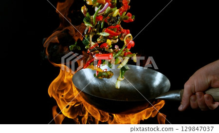 Freeze Motion of Flying Asian Wok Ingredients with Fire Flames Freeze Motion of Flying Asian Wok Ingredients with Fire Flames 129847037