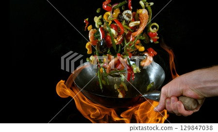 Freeze Motion of Flying Asian Wok Ingredients with Fire Flames 129847038