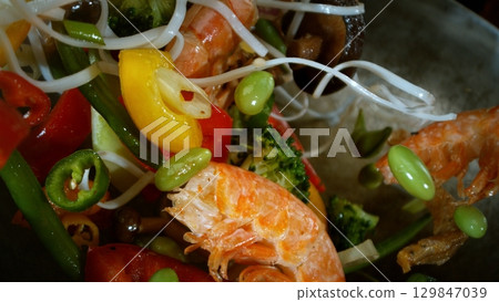 Freeze Motion of Flying Asian Wok Ingredients with Fire Flames 129847039