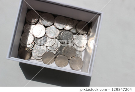 Ukrainian coins denomination 1 and 2 hryvnia in a cardboard box studio isolated stock photo  129847204